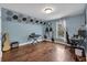 A unique bedroom with hardwood floors, a window with natural light, and soundproofing hexes displayed on the walls at 1007 Springharbor Walk, Woodstock, GA 30188