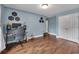 A bedroom with hardwood floors, a window with natural light, soundproofing hexes displayed on the walls and a closet at 1007 Springharbor Walk, Woodstock, GA 30188