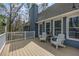 Cozy outdoor deck featuring white chairs, white railing and a great backyard view of trees at 1007 Springharbor Walk, Woodstock, GA 30188