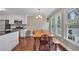 Bright dining area featuring hardwood floors and multiple windows providing natural light at 1007 Springharbor Walk, Woodstock, GA 30188