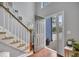 Bright foyer featuring wood floors, staircase, and gray paint at 1007 Springharbor Walk, Woodstock, GA 30188