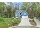 Charming blue two-story home with manicured lawn and two-car garage at 1007 Springharbor Walk, Woodstock, GA 30188