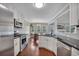 Kitchen view with stainless appliances, granite counters, hardwood floors, dining area and fireplace at 1007 Springharbor Walk, Woodstock, GA 30188