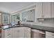 Modern kitchen with stainless steel appliances, granite countertops, and breakfast bar; view to living space at 1007 Springharbor Walk, Woodstock, GA 30188
