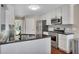 Kitchen with stainless steel appliances, granite countertops, and hardwood floors; bright and efficient at 1007 Springharbor Walk, Woodstock, GA 30188