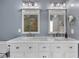 Main bathroom with double sink vanity, globe lighting, and elegant mirrors at 1007 Springharbor Walk, Woodstock, GA 30188