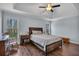 Charming main bedroom featuring a tray ceiling, wood floors and two windows overlooking a treed yard at 1007 Springharbor Walk, Woodstock, GA 30188