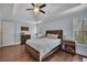Bright main bedroom featuring a tray ceiling, wood floors and large picture window at 1007 Springharbor Walk, Woodstock, GA 30188