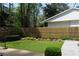 A well-manicured backyard with a lush lawn, a wood fence, and mature trees for privacy at 1428 Brook Valley Ne Ln, Atlanta, GA 30324