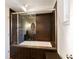 This bathroom features a shower and bathtub combination with stylish brown tile and glass doors at 1428 Brook Valley Ne Ln, Atlanta, GA 30324