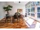 Dining room with a glass table, skylight, floor-to-ceiling windows, and views of the outdoor living space at 1428 Brook Valley Ne Ln, Atlanta, GA 30324