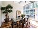 Bright dining room featuring a glass table, hardwood floors, a skylight and sliding doors to the backyard at 1428 Brook Valley Ne Ln, Atlanta, GA 30324