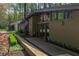 Unique, mid-century home with a modern wood pathway leading to the front entrance and an American flag at 1428 Brook Valley Ne Ln, Atlanta, GA 30324