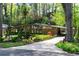Contemporary home features a beautiful front yard with mature trees and unique architectural elements at 1428 Brook Valley Ne Ln, Atlanta, GA 30324