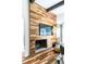 Cozy living room details featuring a unique wood accent wall, modern fireplace and hardwood flooring at 1428 Brook Valley Ne Ln, Atlanta, GA 30324