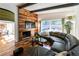 Chic living room showcasing a leather sectional, a wood accent wall and bright views of the backyard at 1428 Brook Valley Ne Ln, Atlanta, GA 30324
