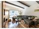 Stylish living room boasts a comfortable leather couch, hardwood floors, and a large window overlooking the backyard at 1428 Brook Valley Ne Ln, Atlanta, GA 30324