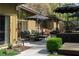Outdoor patio with comfortable seating, a grill, lush landscaping, and stylish umbrellas at 1428 Brook Valley Ne Ln, Atlanta, GA 30324