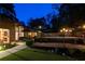 Inviting backyard with a pool, patio furniture, and manicured landscaping, perfect for evening relaxation at 1428 Brook Valley Ne Ln, Atlanta, GA 30324