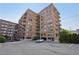 Brick building featuring arched windows, balconies, parking and street-level entry at 3235 Roswell Ne Rd # 801, Atlanta, GA 30305
