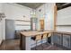 Modern kitchen featuring an island with seating, stainless steel appliances, and gray cabinets at 3235 Roswell Ne Rd # 801, Atlanta, GA 30305
