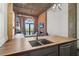 Spacious open-concept kitchen with island, stainless appliances, and exposed brick and ductwork at 3235 Roswell Ne Rd # 801, Atlanta, GA 30305