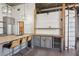 Stylish kitchen showcasing an island with seating, wine cooler, custom shelving, and modern lighting at 3235 Roswell Ne Rd # 801, Atlanta, GA 30305