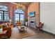 Bright living room with brick accent wall, fireplace, modern lighting, and comfortable leather furniture at 3235 Roswell Ne Rd # 801, Atlanta, GA 30305