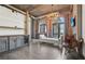 Open living space with exposed ductwork, brick accents, and a modern kitchen, bathed in natural light at 3235 Roswell Ne Rd # 801, Atlanta, GA 30305