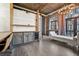 Open concept living space with exposed brick, high ceilings, custom shelving, and balcony access at 3235 Roswell Ne Rd # 801, Atlanta, GA 30305