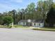 Charming single story home with a cozy front yard surrounded by mature trees and a paved road at 3385 Huntington Ct, Douglasville, GA 30134