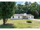 Picture-perfect single-story home featuring a well-manicured lawn, white siding, and a lovely front yard at 3385 Huntington Ct, Douglasville, GA 30134
