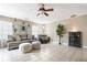 Spacious living room featuring tile floors, ample seating, and natural lighting from the windows at 3385 Huntington Ct, Douglasville, GA 30134