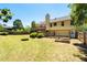 Large backyard with a fire pit, garden beds, and a spacious deck at 3540 Owl Brow Ct, Cumming, GA 30028