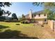 Expansive fenced backyard featuring a deck, fire pit, and garden beds for outdoor enjoyment at 3540 Owl Brow Ct, Cumming, GA 30028