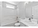Bathroom with a shower-tub combo, neutral paint, and a sink with storage at 3540 Owl Brow Ct, Cumming, GA 30028