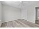 Spacious bedroom with ceiling fan, wood-look floors, and closet at 3540 Owl Brow Ct, Cumming, GA 30028