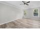 Bedroom featuring hardwood floors and a tray ceiling with recessed lighting at 3540 Owl Brow Ct, Cumming, GA 30028