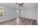 Bedroom featuring luxury vinyl flooring and large window and ceiling fan at 3540 Owl Brow Ct, Cumming, GA 30028