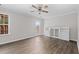 View of a bedroom with hardwood floors, ceiling fan, and plenty of natural light at 3540 Owl Brow Ct, Cumming, GA 30028