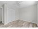 Clean bedroom with ceiling fan, wood-look floors, and a large closet at 3540 Owl Brow Ct, Cumming, GA 30028