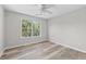 Bedroom with a ceiling fan, window and wood flooring at 3540 Owl Brow Ct, Cumming, GA 30028