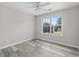 Bedroom with a large window providing natural light and wood flooring at 3540 Owl Brow Ct, Cumming, GA 30028