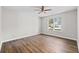 This bedroom boasts hardwood floors and a ceiling fan for added comfort at 3540 Owl Brow Ct, Cumming, GA 30028