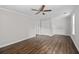 This spacious bedroom features hardwood floors, neutral walls, and a ceiling fan at 3540 Owl Brow Ct, Cumming, GA 30028