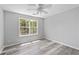 Light and airy bedroom with neutral paint and large window with view at 3540 Owl Brow Ct, Cumming, GA 30028