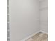 Walk-in closet with shelving units and hardwood floors at 3540 Owl Brow Ct, Cumming, GA 30028