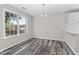 Dining area with a modern chandelier and a large window overlooking backyard at 3540 Owl Brow Ct, Cumming, GA 30028