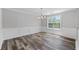 Bright dining area featuring stylish floors, wainscoting, and a chandelier for elegant dining at 3540 Owl Brow Ct, Cumming, GA 30028