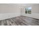 Dining room with gray wood floors, chair rail, crown molding and bright natural light at 3540 Owl Brow Ct, Cumming, GA 30028